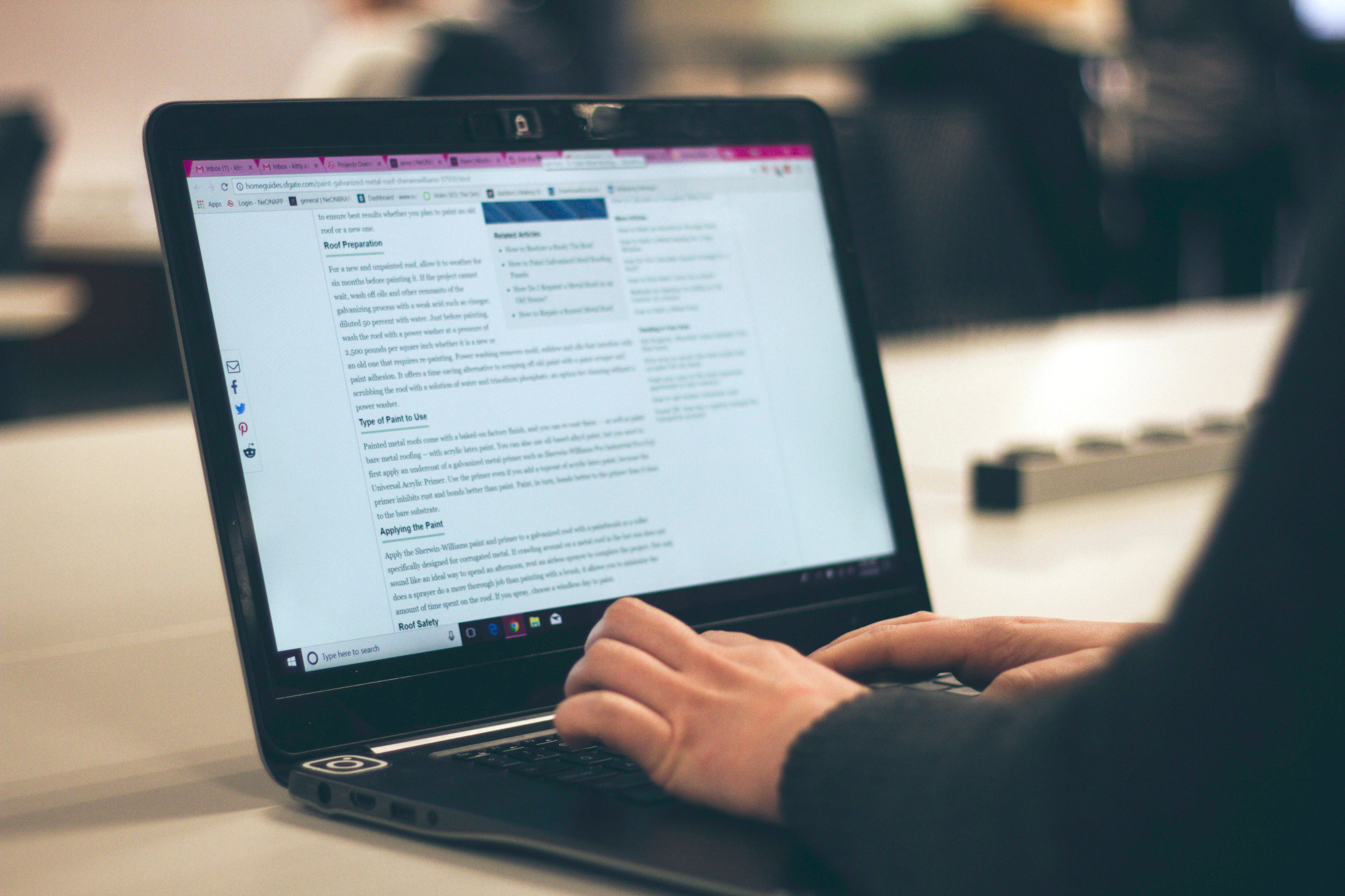 Person's hands typing on a notebook computer